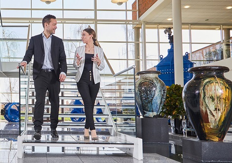 AVK entrance hall with two people talking walking down the stairs